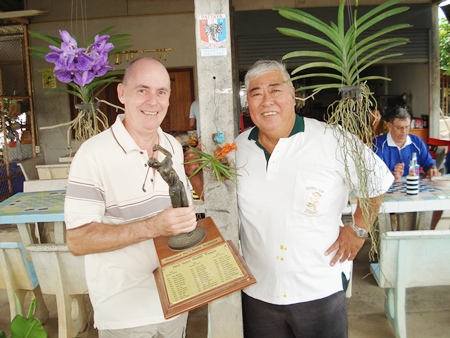 Winner Richard Hall, left, with the monthly trophy, is flanked by runner up Herb Ishinaga.